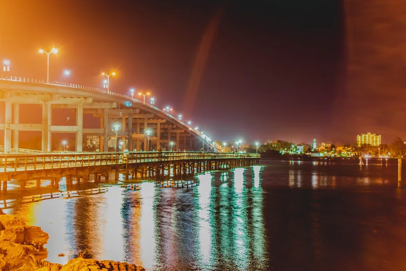A Florida bridge lit up at night over the water