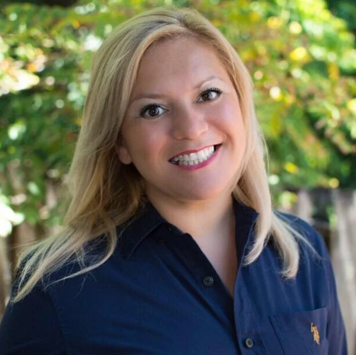 Patti, founder of P.S. Marketing Maven, smiling outdoors in a navy shirt