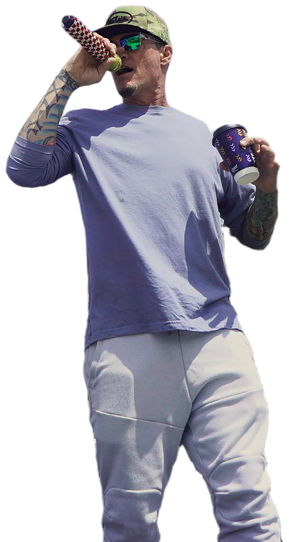 Vanilla Ice singing into a microphone on stage