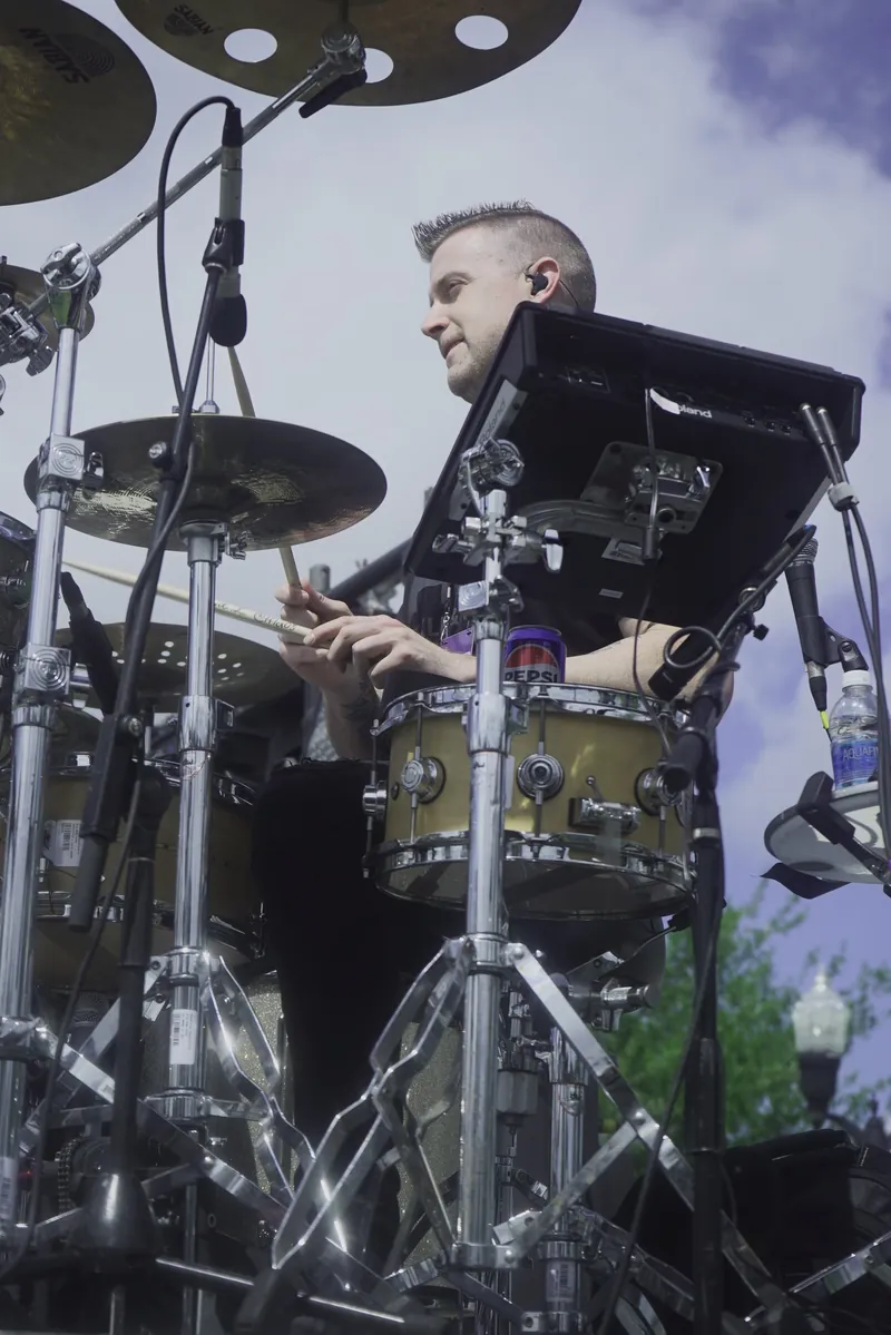 A drummer playing behind the kit on stage